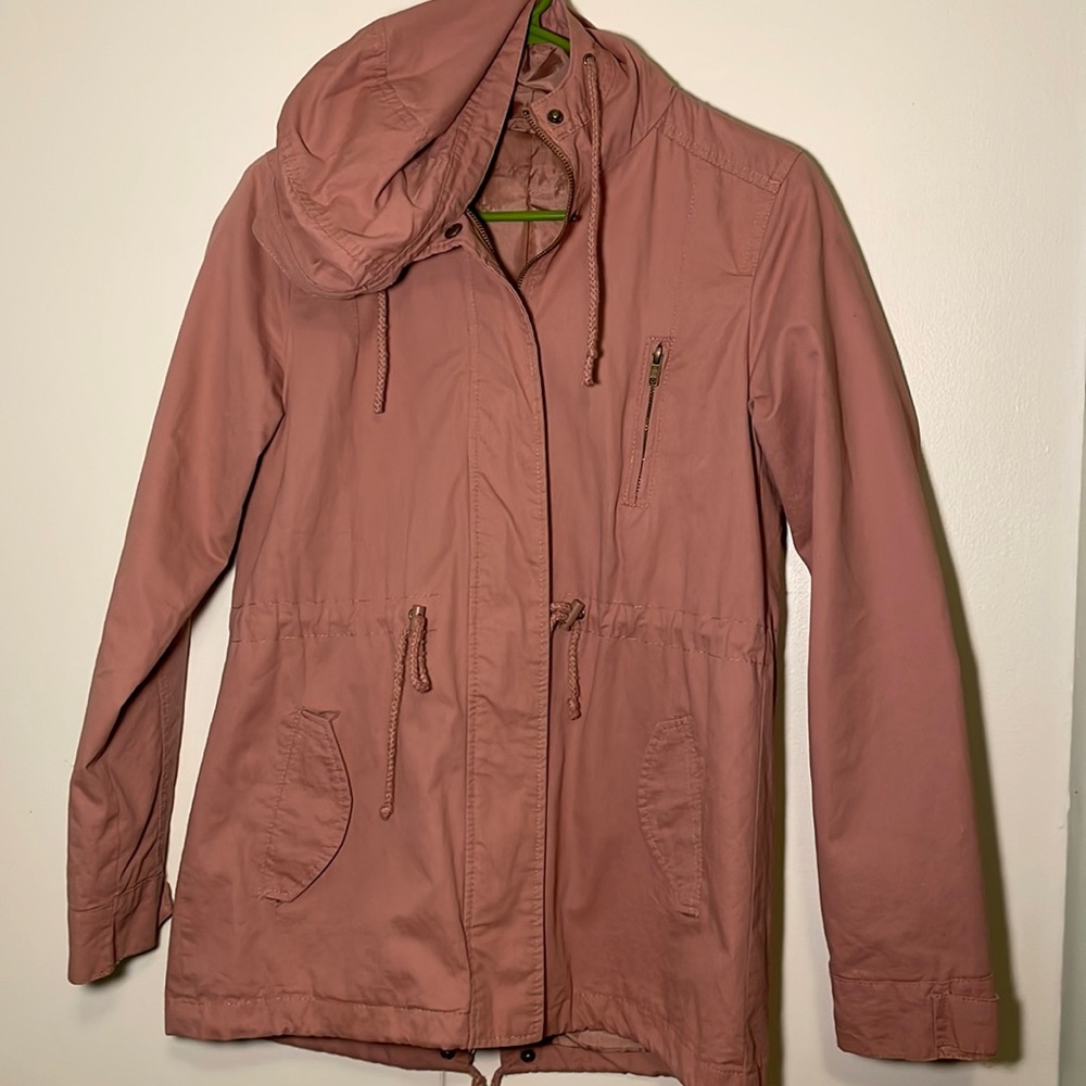 Pink trench coat, slight damage around right hand pocket, adjustable waist